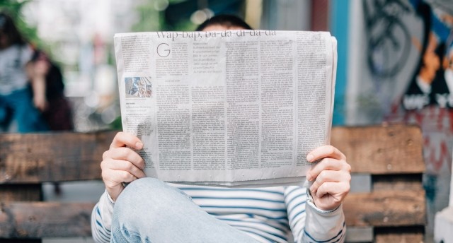 Person reading newspaper